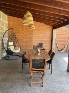 a wooden table and chairs on a patio at Refúgio da Légua in Marco de Canavezes