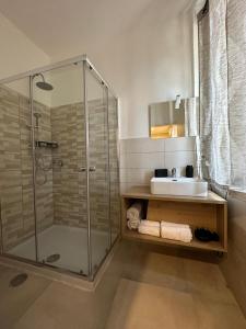 a bathroom with a glass shower and a sink at B&B Residenza De Rose in Cosenza