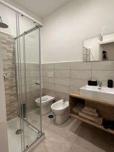 a bathroom with a shower and a toilet and a sink at B&B Residenza De Rose in Cosenza