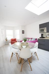 a white living room with a table and chairs at Oceans 12a Shelley Lofts, sleeps 4 in Worthing