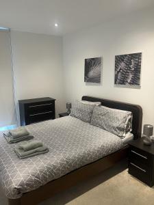 a bedroom with a bed with two pillows on it at Luxurious 1 Bedroom Apartment In Croydon in Croydon