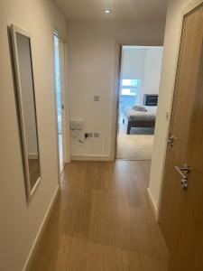 a hallway with a door and a room with a bed at Luxurious 1 Bedroom Apartment In Croydon in Croydon