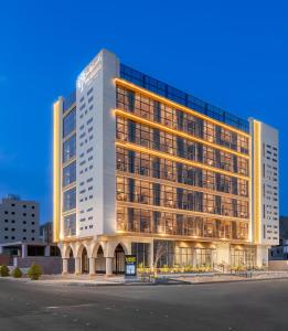 a tall white building with a lot of windows at The Seasons Hotel in Al Madinah