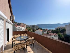 a balcony with chairs and a table on a roof at Apartments Lav Costas in Herceg-Novi