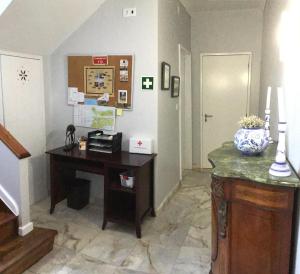 an office with a desk and a hallway with a door at Pousada da Vila in Vila Franca do Campo
