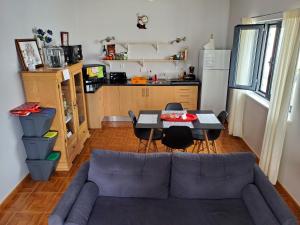 a living room with a couch and a table at Pousada da Vila in Vila Franca do Campo