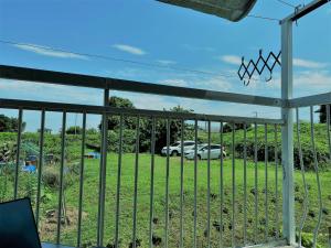 a fence with a car parked in a field at Shonan no Oka no Villa - Vacation STAY 24013v in Fujisawa