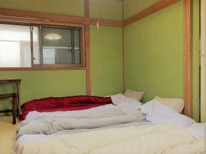 a large bed in a room with green walls at Shonan no Oka no Villa - Vacation STAY 24013v in Fujisawa