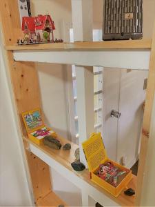 a shelf with a toy house and books on it at Shonan no Oka no Villa - Vacation STAY 24987v in Fujisawa