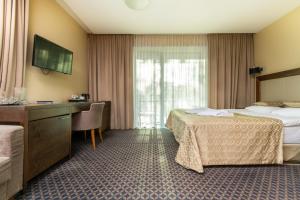 Postel nebo postele na pokoji v ubytování Grand SPA Lietuva Hotel Druskininkai