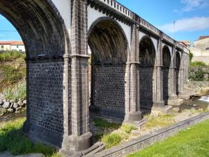 a bridge with arches on the side of a river at Pousada da Vila in Vila Franca do Campo