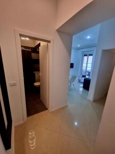 a hallway with a door open to a living room at Bass Apartment in Pula
