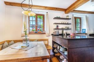 a kitchen with a wooden counter and a table at Landhaus Gustl in Chieming