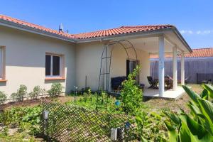 a house with a gazebo in a yard at La maison du bonheur in Biscarrosse