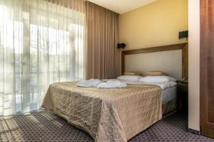 Postel nebo postele na pokoji v ubytování Grand SPA Lietuva Hotel Druskininkai
