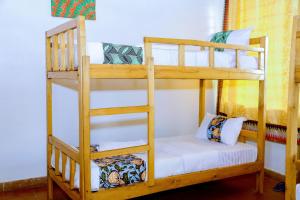a couple of bunk beds in a room at INZOZI AFRICA HOUSE B&B-Kimihurura in Kigali