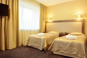 Postel nebo postele na pokoji v ubytování Grand SPA Lietuva Hotel Druskininkai