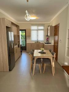 a kitchen with a table and chairs in a room at Pearl Gate Residence Apt No 3 in Flic-en-Flac