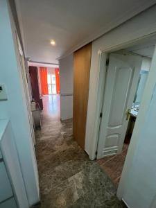 an empty room with a hallway with a door and a bathroom at Apartamentos COZYNNS II in Torremolinos