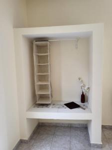 a room with a white wall with shelves at Asamai Villas 