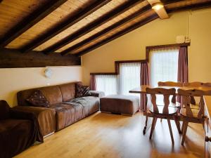 a living room with a couch and a table at Apartments Atlas in Saas-Grund