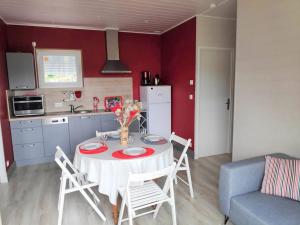 a kitchen with a table and chairs in a room at Baie du Mont Saint Michel / Gîte de la Vaquerie in Vains
