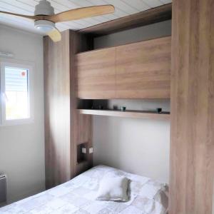 a bedroom with a bed and a ceiling fan at Baie du Mont Saint Michel / Gîte de la Vaquerie in Vains