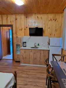 a kitchen with a sink and a refrigerator at Комплекс Джулай Морнинг in Kiten