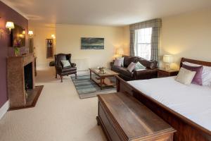 a bedroom with a bed and a living room at Boreham House in Herstmonceux