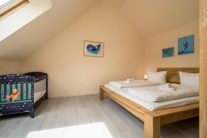 a bedroom with two beds and a crib at Fischerhaus 309 in Rechlin