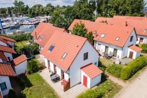 an aerial view of a group of houses with a marina at Fischerhaus 309 in Rechlin
