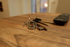 a pair of keys on a table next to a remote control at Casa vacanze San Francesco in Barletta