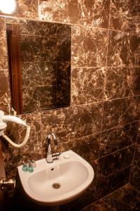 a bathroom with a sink and a mirror at Istanbul Irish Hotel in Istanbul