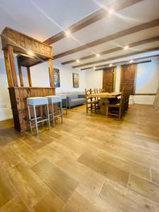 a living room with wooden floors and a table and chairs at El 42 MIJARES in Mijares +122 photos