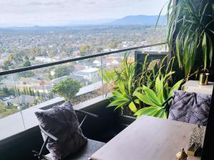 a balcony with a table and pillows and a view at Modern&cozy life in Sky Garden 5min from station in Glen Waverley