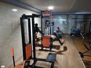 a gym with a person in a gym with machines at Pool, Sauna, Gym & Spa @ Beach-Front Apartment Hotel in Ashkelon