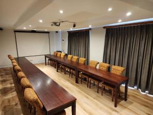 a conference room with a long table and chairs at Dark Chocolate Guest House in Durbanville