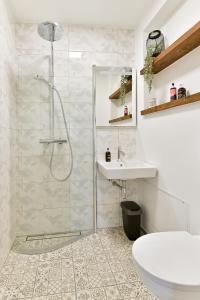 a bathroom with a shower and a sink at Kuressaare Pikk Apartment in Kuressaare