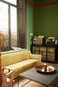 a living room with a couch and a table at Heirloom Hotels - The Mansion in Ghent