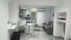 a kitchen and living room with a couch and a table at KM LUXURY APART DOWNTOWN in Heraklio