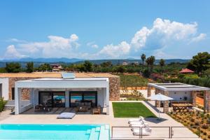 a view of a villa with a swimming pool at Nobus Villas - Luxury villa with Private pool, sea view & sunset in Marathopolis