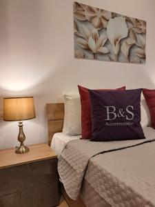 a bedroom with a bed and a picture on the wall at B&S Accommodation Seafront Duplex Penthouse in Marsaskala
