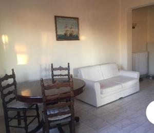 a living room with a couch and a table and chairs at Farmhouse in Volímai