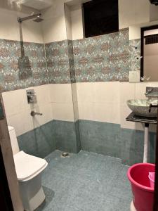 a bathroom with a toilet and a sink at HOTEL DIVYA in Rishīkesh