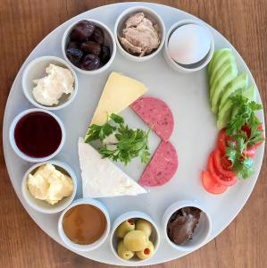 a plate with different types of cheese and other foods at New Pera Hotel in Istanbul