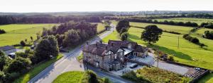 an aerial view of a large house in a field at Bramall House Accommodation in Fewston