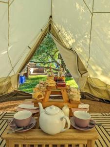 a tent with a tea set on a table at Stoffhaus in Skipton