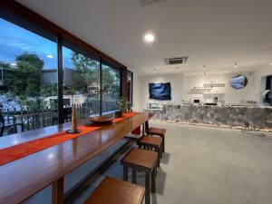 a large dining room with a long table and chairs at Nhapha Khaoyai Resort in Mu Si