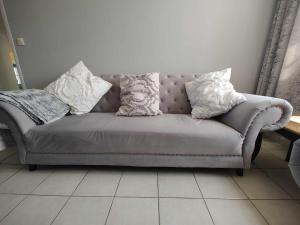a couch with pillows on it in a living room at Perfect Gites In Normandy 
