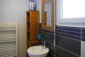 a bathroom with a sink and a mirror at Baie du Mont Saint Michel / Gîte de la Vaquerie 23 in Vains